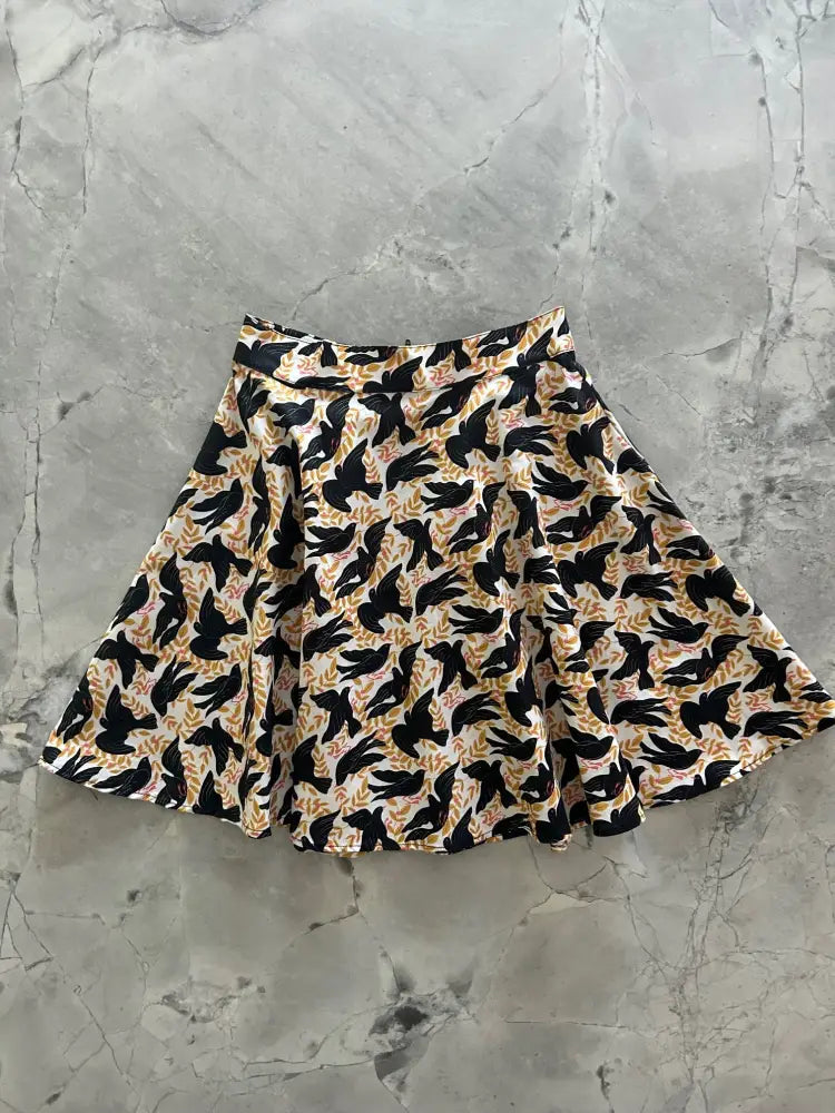 Vintage bird print cotton skater skirt with flared design black bird pattern on cream and gold lightweight fabric