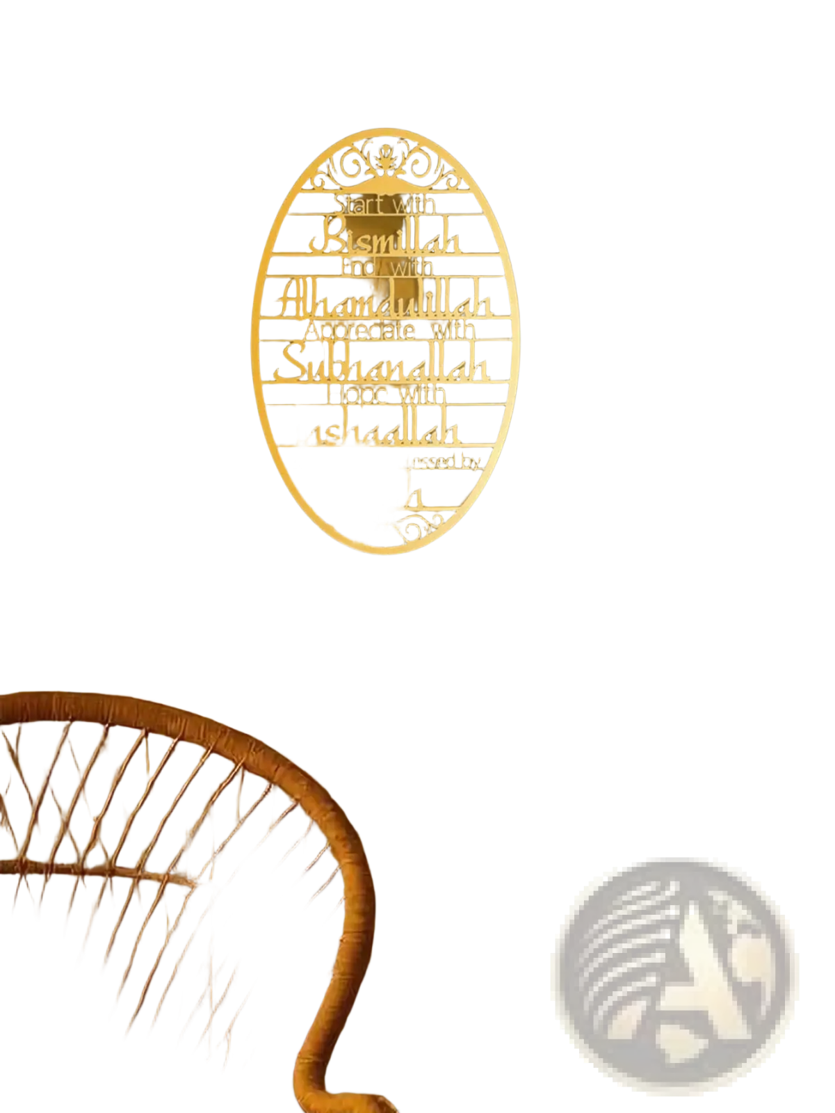 A cream-colored oval metal wall art plaque with intricate scrollwork and engraved islamic phrases used as a key holder hook