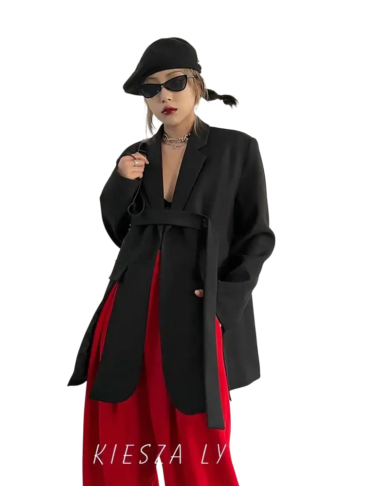 Black belted oversized blazer with structured shoulders in a classic black fabric for a tailored look