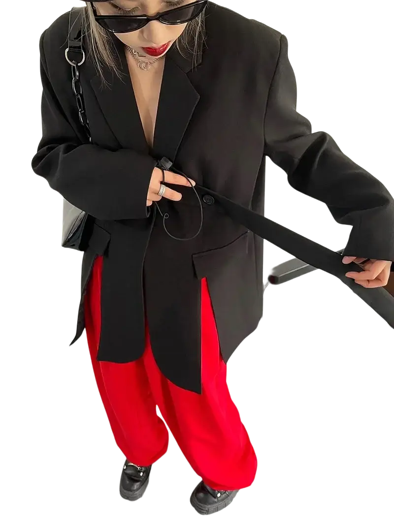 Black belted oversized blazer paired with a black chain strap bag featuring sleek metallic hardware and minimalist design