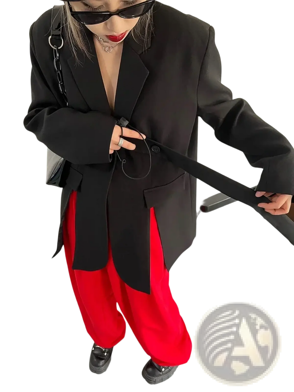 Black belted oversized blazer paired with a black chain strap bag featuring sleek metallic hardware and minimalist design