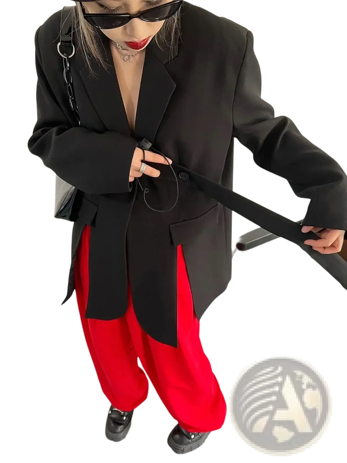 Black belted oversized blazer paired with a black chain strap bag featuring sleek metallic hardware and minimalist design