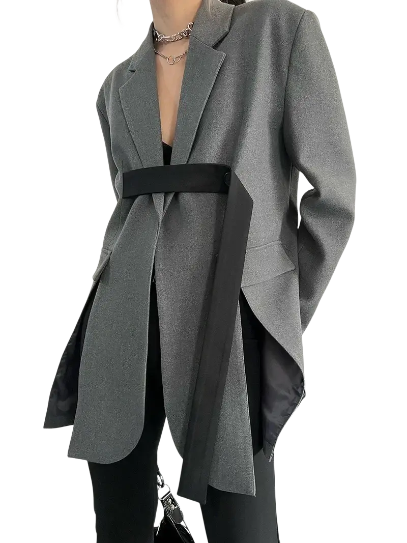 Gray oversized blazer with black belt and asymmetrical hem showcasing a modern tailored design