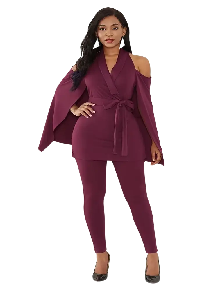 A plus-size woman models a maroon black cape sleeve jumpsuit with belt featuring off-the-shoulder cape sleeves by gbvlgar