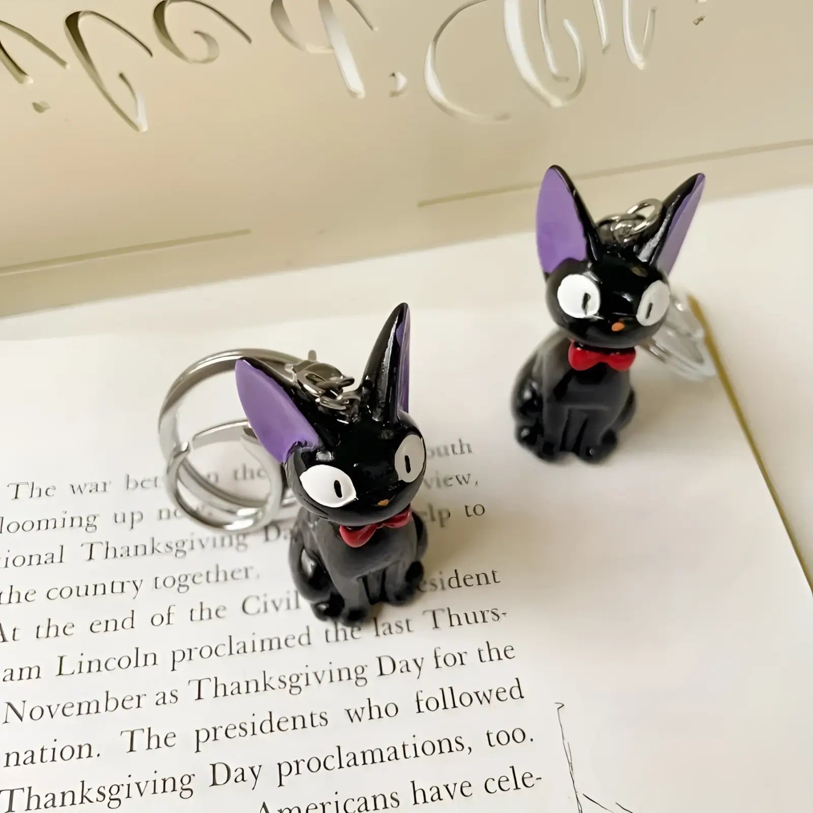Black cat keychain made of pvc with purple ears and red bow tie cute bag charm accessory
