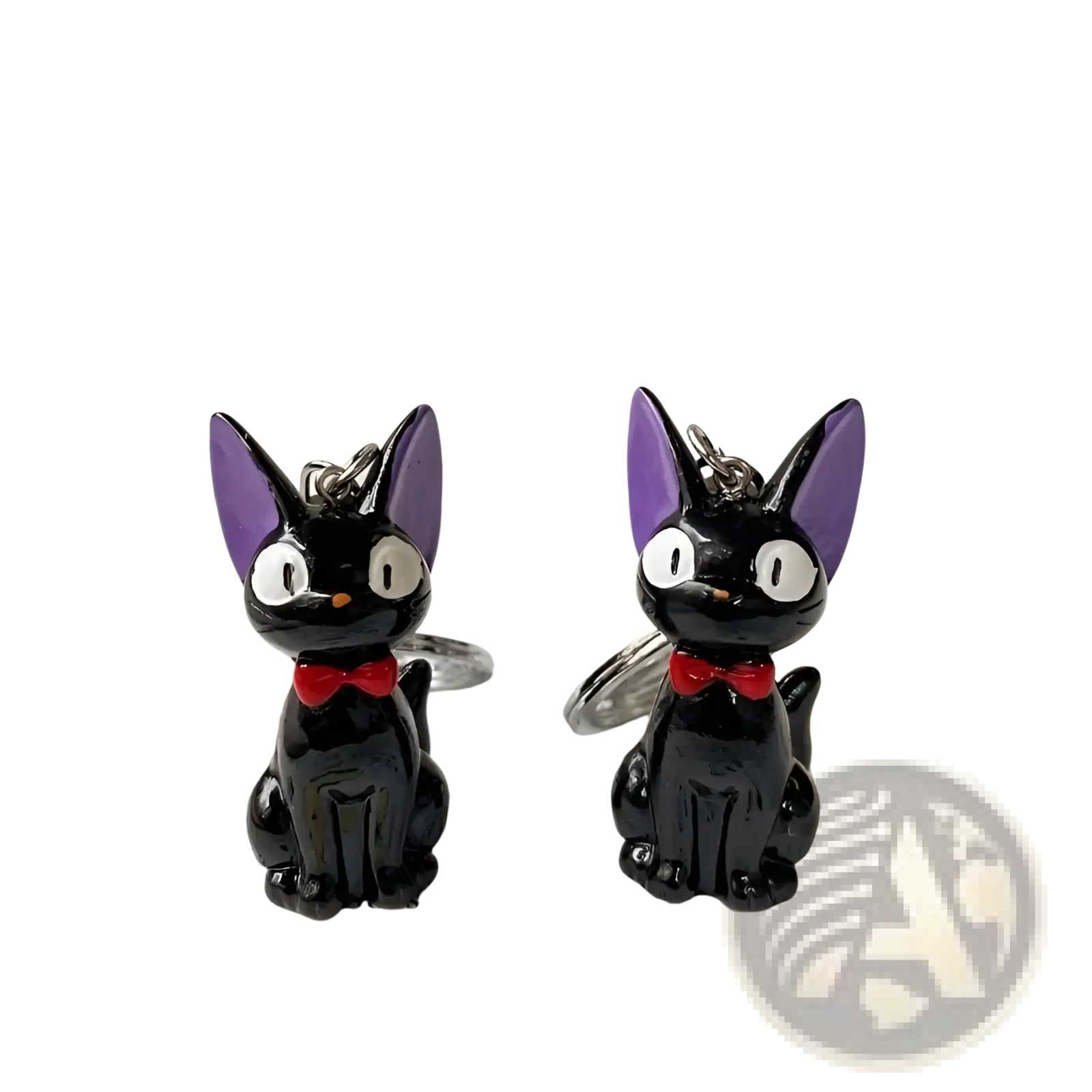 Two glossy black pvc cat keychains with purple ears red bow ties and silver metal rings for bags or keys