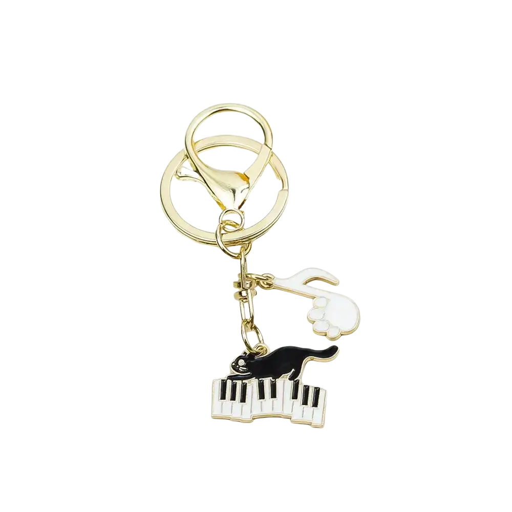 Gold-toned black cat piano keychain with enamel finish and hand and paw print charm for music lovers gift