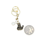 Gold-toned black cat piano keychain with enamel charm featuring purring is very lovely meowsic phrase and white paw print pendant