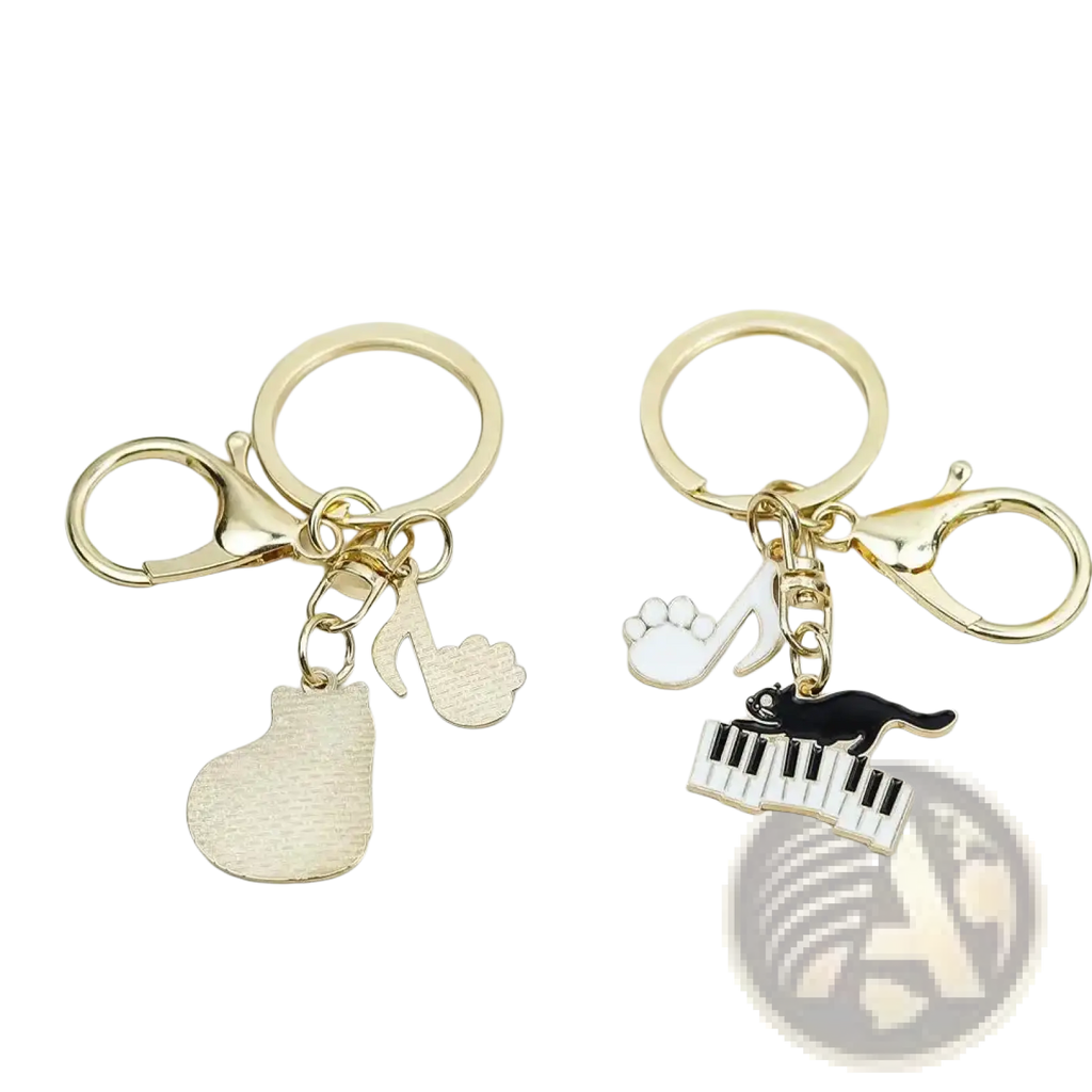 Gold-toned black cat piano keychain featuring musical charms including a piano pendant and enamel cat on keys