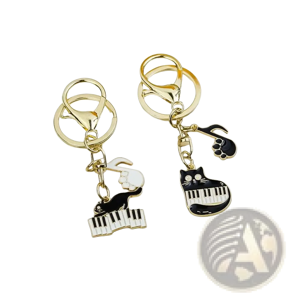 Gold-toned keychains with black and white enamel cat charms playing piano and musical notes for music lovers