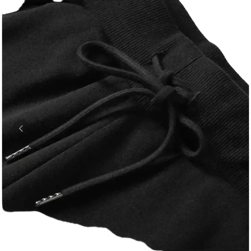 Black corduroy drawstring jogger shorts for women featuring a tied black drawstring with metallic aglets on dark fabric