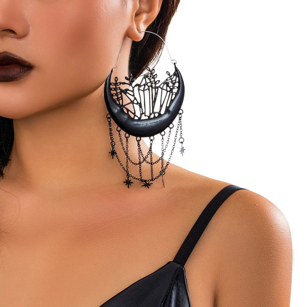 Black crescent moon tassel earrings with intricate crystal cutouts and dangling star chains in black metal