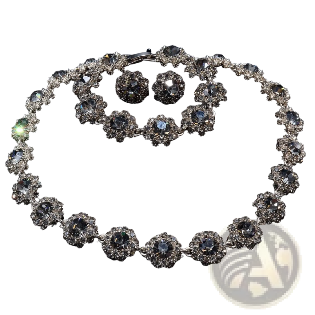 Elegant silver-toned black crystal jewelry set with intricate floral designs featuring clear crystals and rhinestones