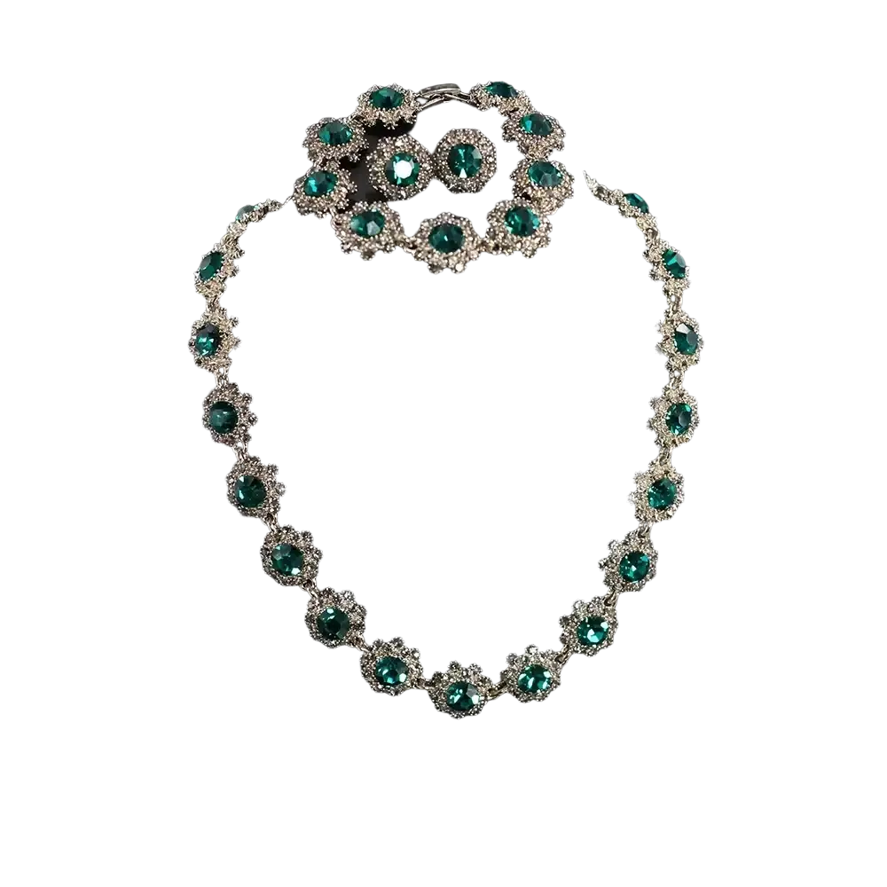 Black crystal jewelry set featuring emerald green rhinestone necklace and matching bracelet with silver toned metalwork