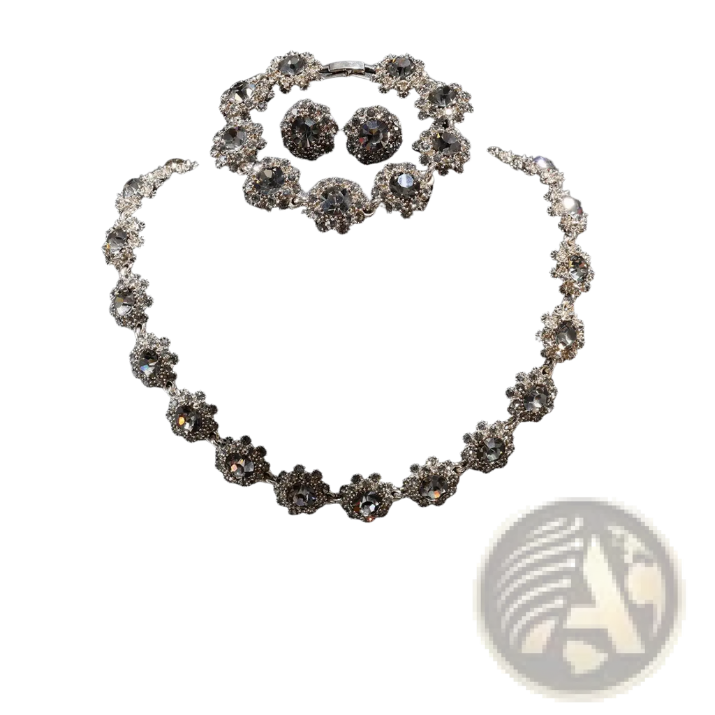 Silver-toned black crystal jewelry set featuring a necklace bracelet and earrings with intricate floral designs