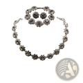 Silver-toned black crystal jewelry set featuring a necklace bracelet and earrings with intricate floral designs