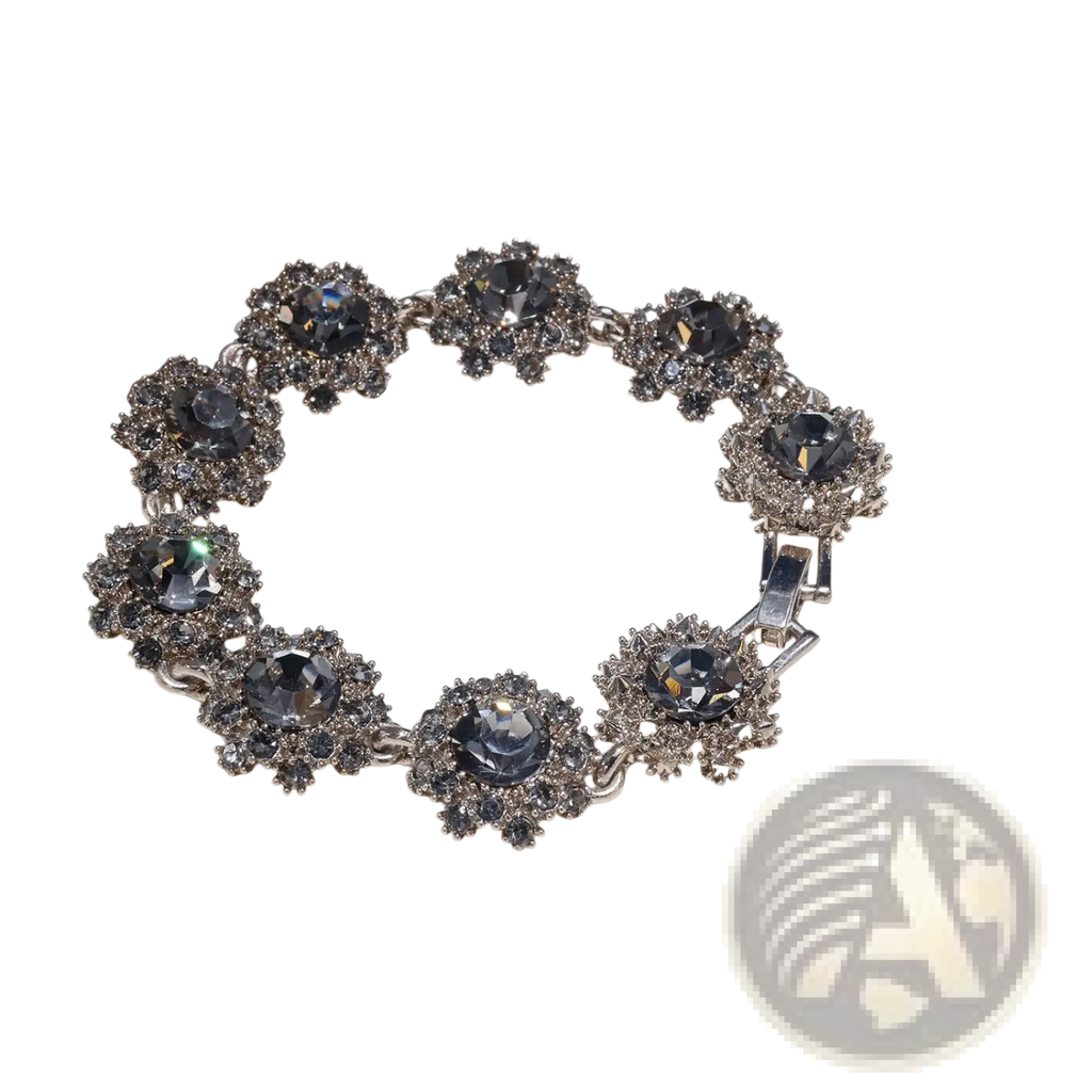 Silver-toned black crystal bracelet with eight ornate flower clusters featuring dark gray and clear rhinestones