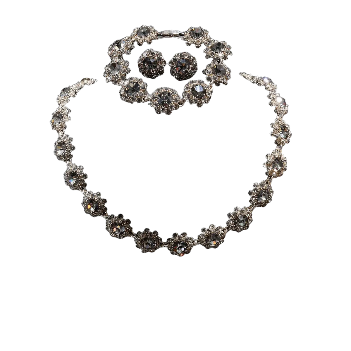 Silver-toned black crystal jewelry set featuring a necklace bracelet and earrings with intricate floral designs