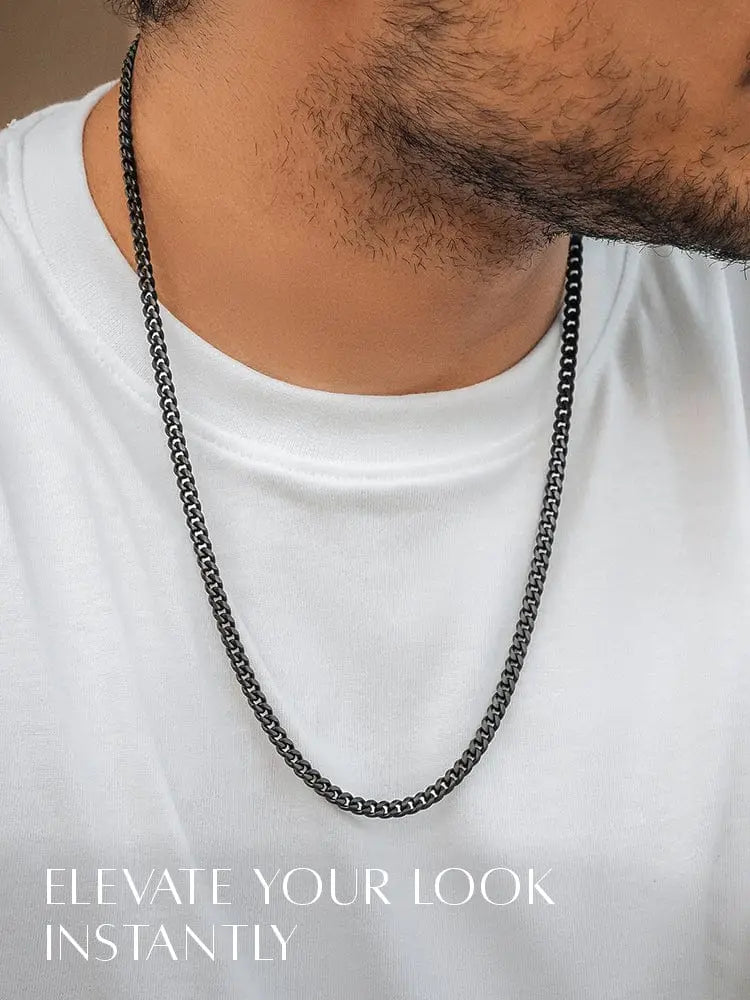 Black diamond cut Cuban link chain necklace in black oxidized stainless steel worn around the neck