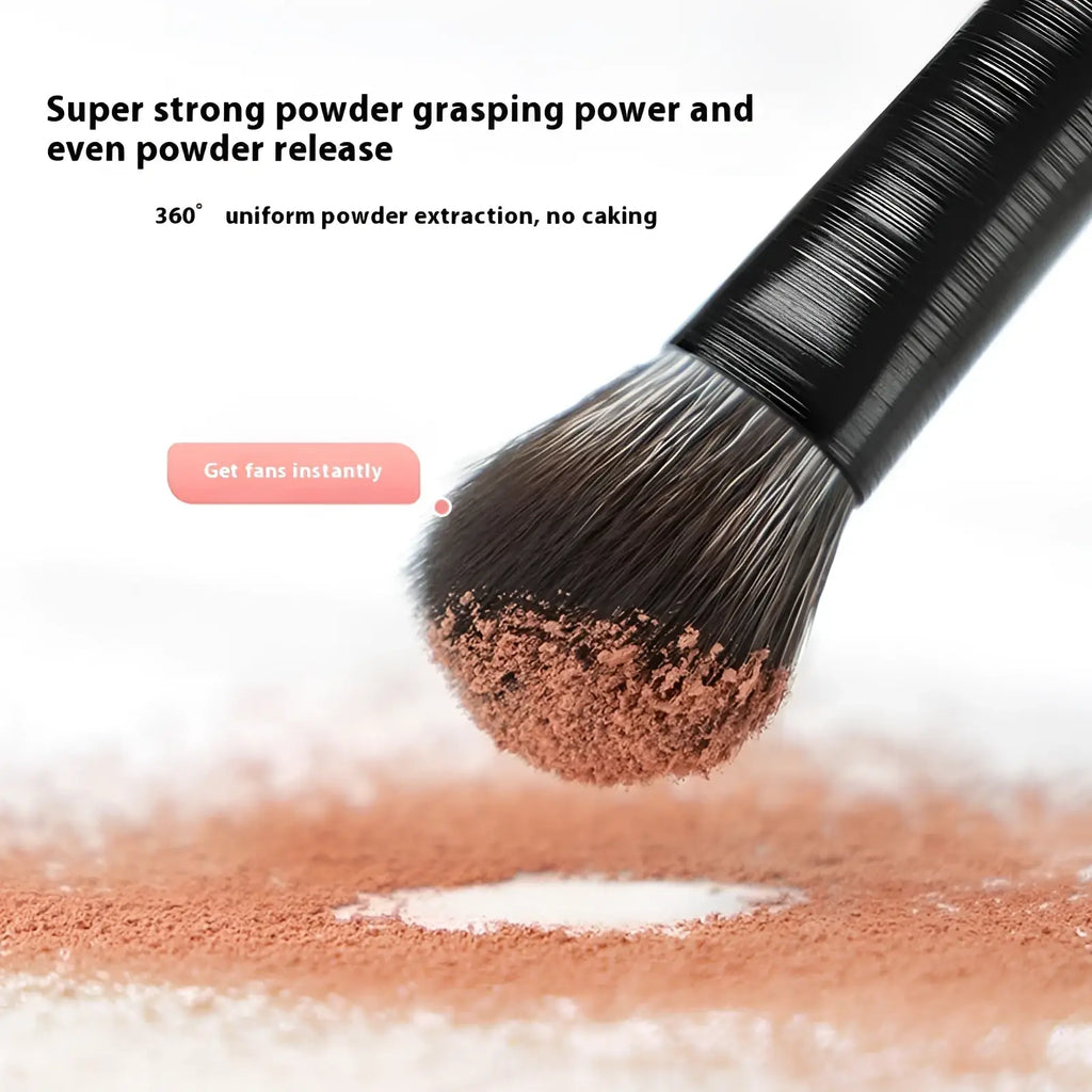 A black-handled black eye makeup brush with dense bristles holding brown powdered makeup from a 10 piece matte set