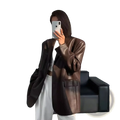A sleek oversized brown leather blazer with glossy finish and structured shoulders for women loose fit jacket