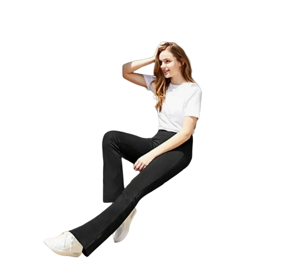 Woman wearing black flare yoga pants with pockets and a white t-shirt sitting on the step of a camper van
