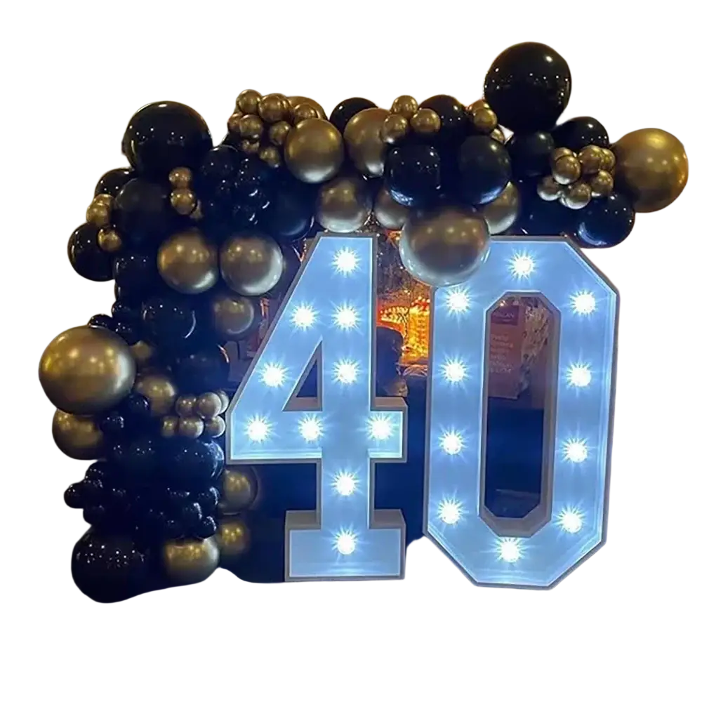 Illuminated blue 40 sign with light bulbs surrounded by black and gold balloons in black and gold balloon arch kit for parties