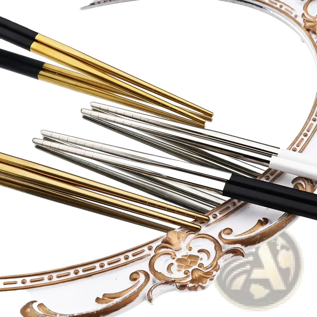 Set of elegant gold and silver metallic stainless steel chopsticks with black handles from the Black Gold flatware set 18pcs