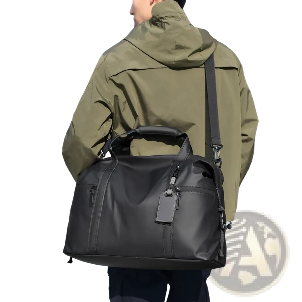 Black gym duffel bag made of nylon with a top handle and adjustable shoulder strap for travel and fitness gear use