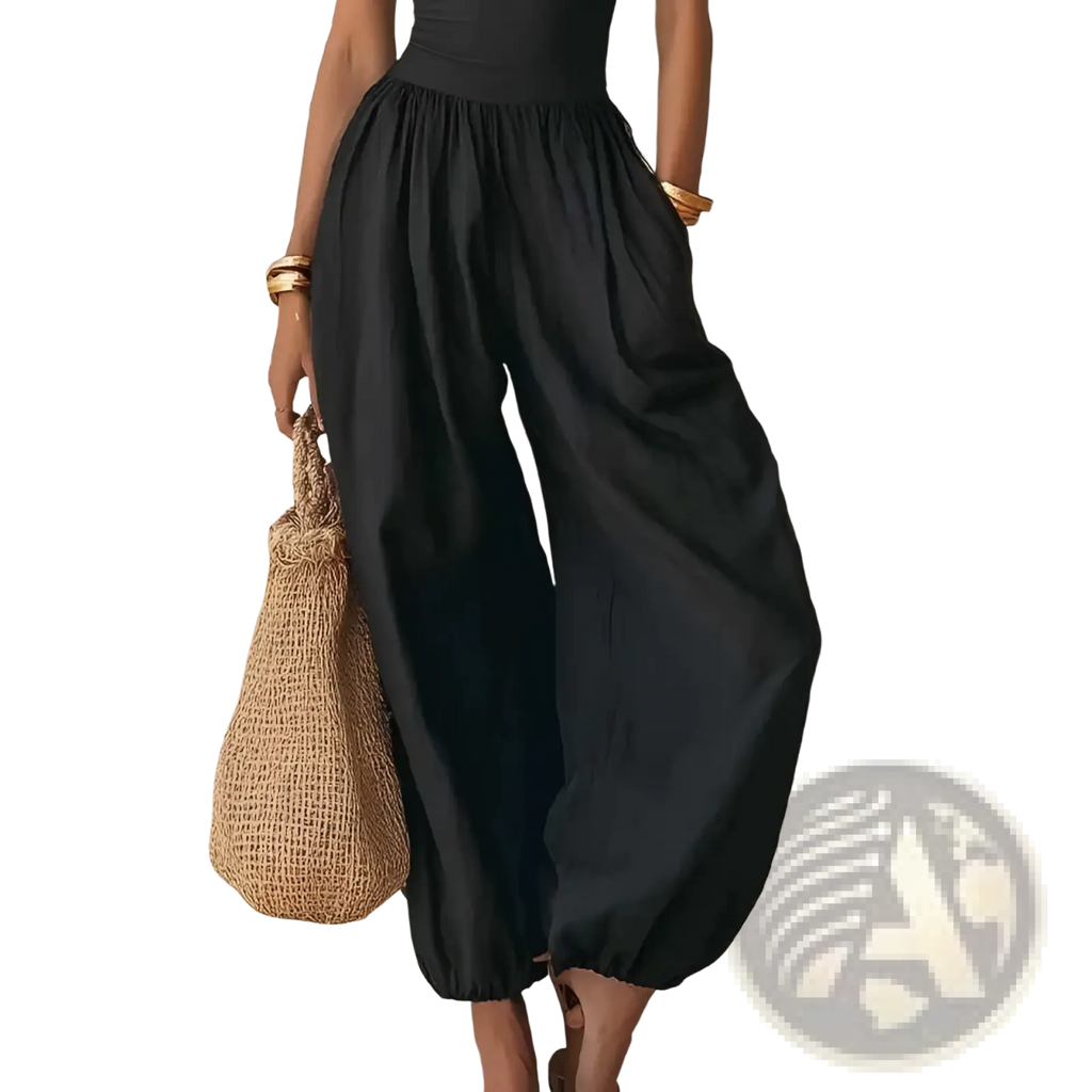Black halter wide leg jumpsuit featuring black high-waisted wide-leg pants with elasticated cuffs and flowing silhouette