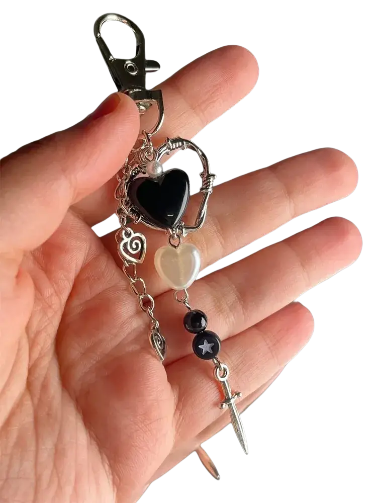 Black heart dagger keychain aesthetic charm with a black resin heart wirework and silver-toned metal accents with pearls and sword pendant
