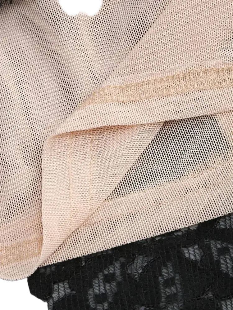 Beige mesh fabric with subtle sheen layered over black lace on a black lace corset party dress