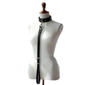 Black leather bondage collar and leash set with adjustable strap and silver-toned metal hardware on mannequin