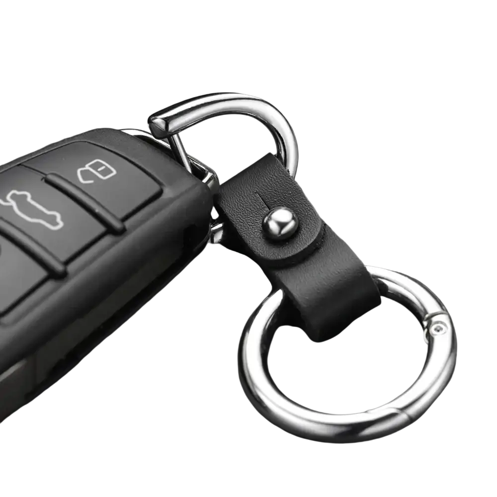 Black leather car keychain with silver metal ring and carabiner attached to a black remote fob