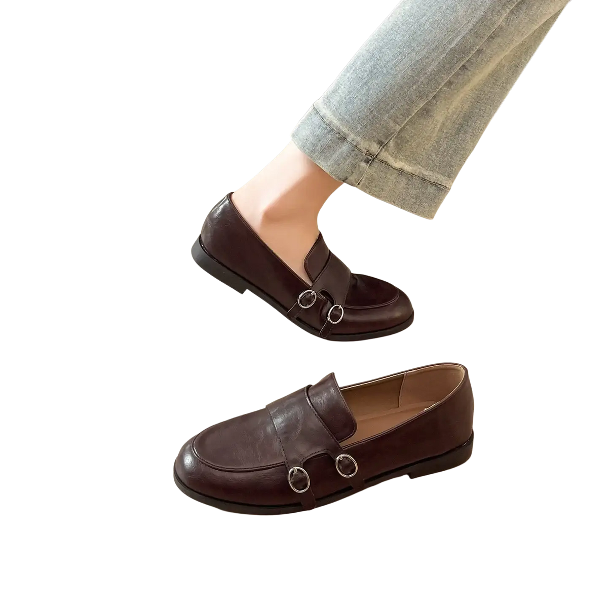 Dark brown leather loafers with classic design featuring two silver-toned circular buckles on the front
