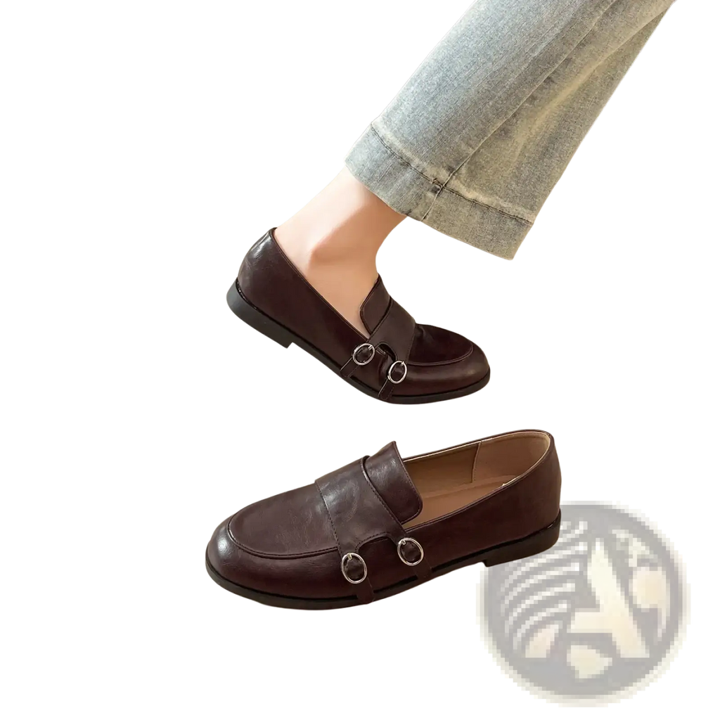 Dark brown leather loafers with classic design featuring two silver-toned circular buckles on the front