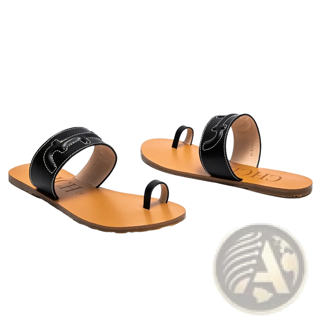 Black leather flat sandals featuring distinctive cutout strap design with tan leather soles for casual wear