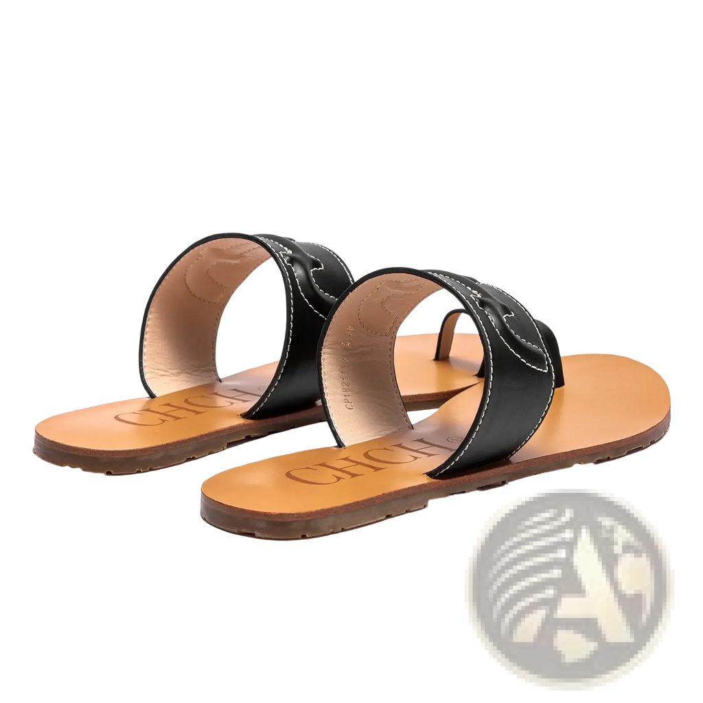 Black leather flat sandals with white stitching and tan rubber sole designed as slide sandals