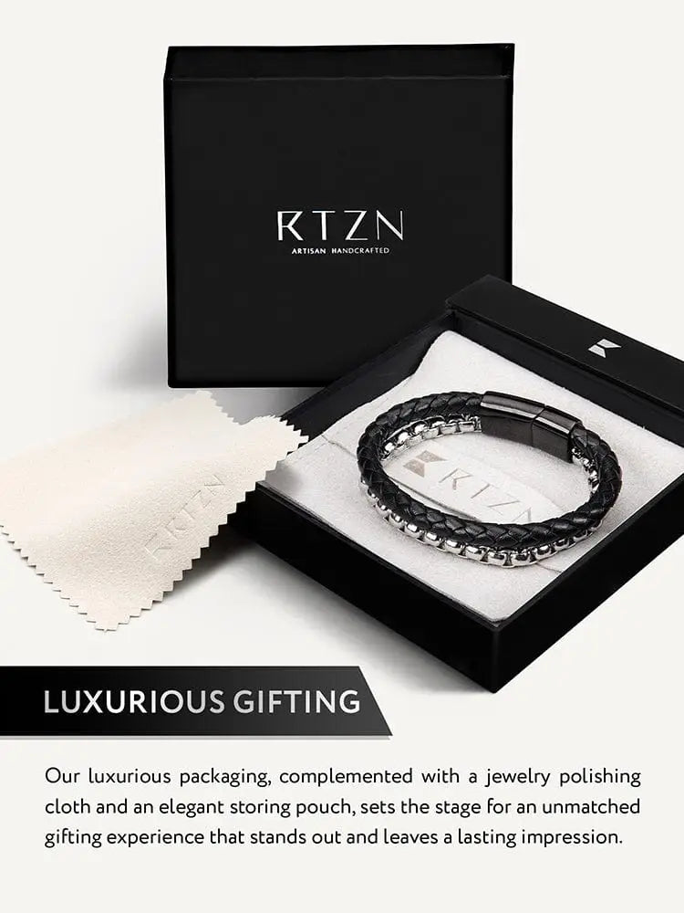Black braided leather and silver box chain bracelet with a sleek silver clasp in an elegant black gift box
