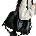 Black faux leather duffle bag with reinforced stitching adjustable straps zipper hidden bag width 40cm thickness 14cm