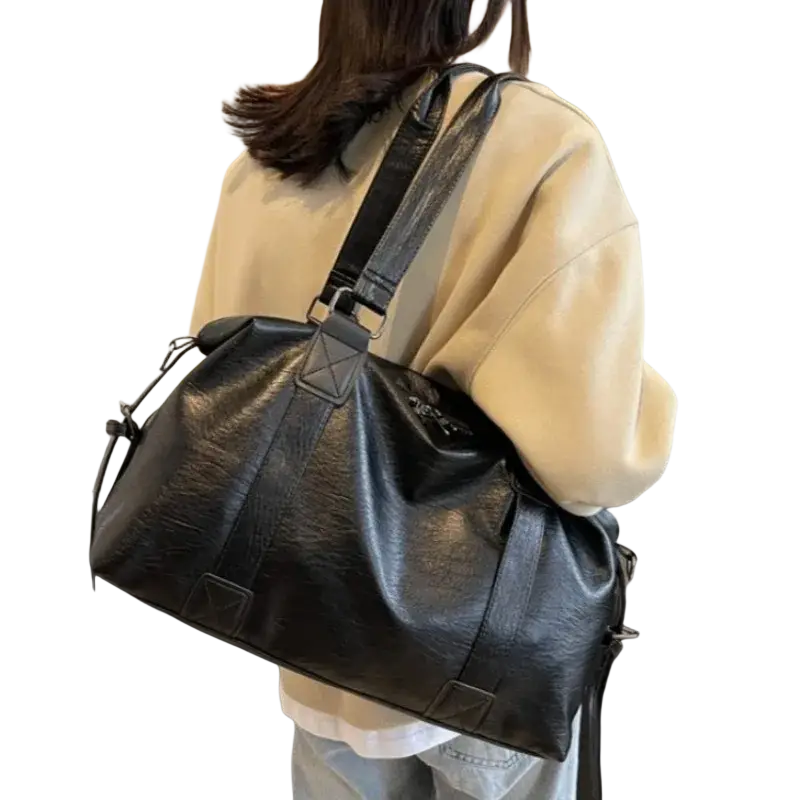 Black faux leather duffel bag with 40cm thickness 14cm, reinforced straps, and a hidden drawstring closure