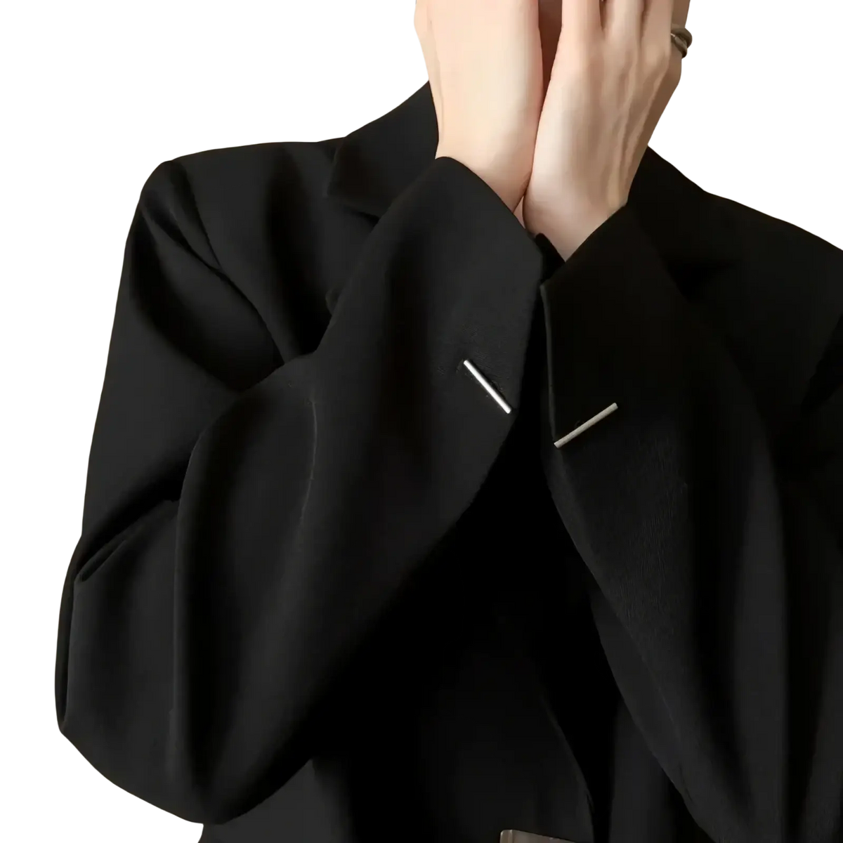 Black minimalist women blazer in sleek fabric featuring silver pin accents for a polished modern look