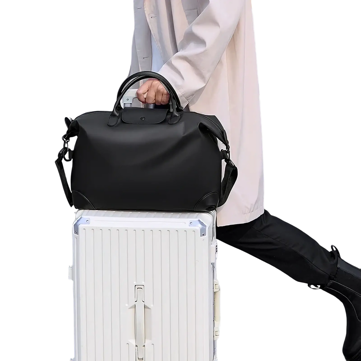 Black leather travel duffle bag with top handle and adjustable shoulder strap for convenient travel use
