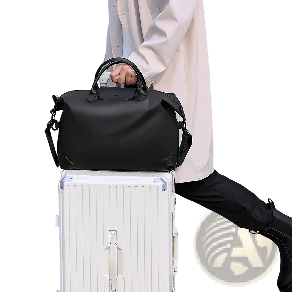 Black leather travel duffle bag with top handle and adjustable shoulder strap for convenient travel use