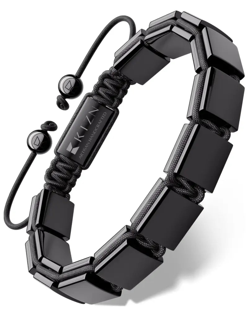 Black ceramic square beads on a black braided cord with adjustable sliding knots and a branded metal tag on bracelet