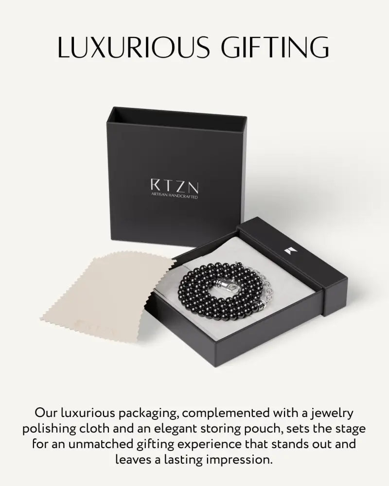 Black obsidian stainless steel beaded necklace in sleek black gift box showcasing elegant craftsmanship and design