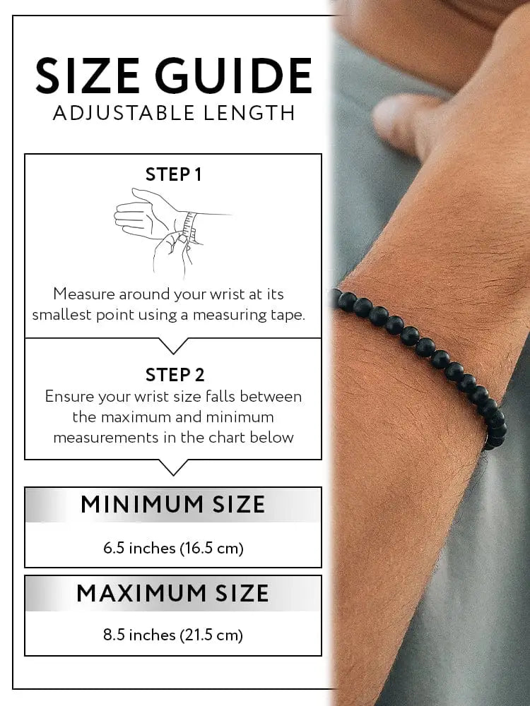 Matte black onyx beaded bracelet with greek key accents worn on wrist showcasing elegant black beads