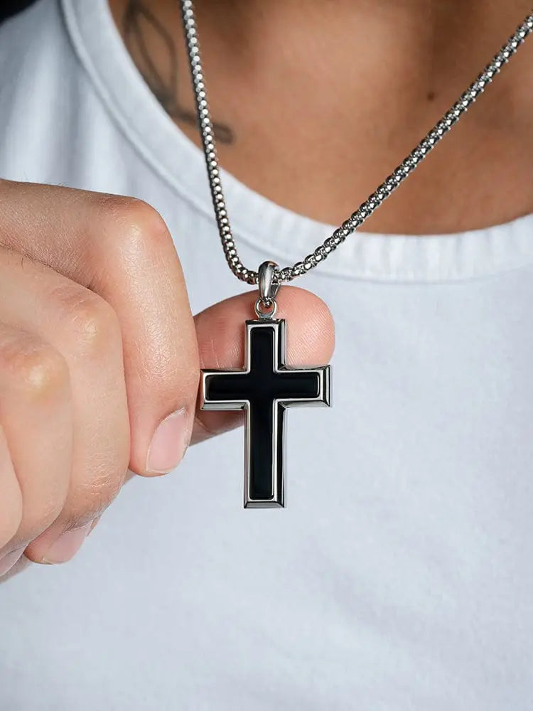 Silver cross pendant with black onyx inlay hanging from matching stainless steel chain in black onyx inlay stainless steel cross necklace