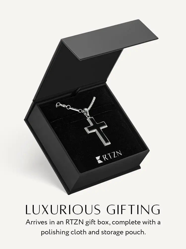 Silver cross pendant necklace with sleek black onyx inlay and delicate stainless steel chain in modern design