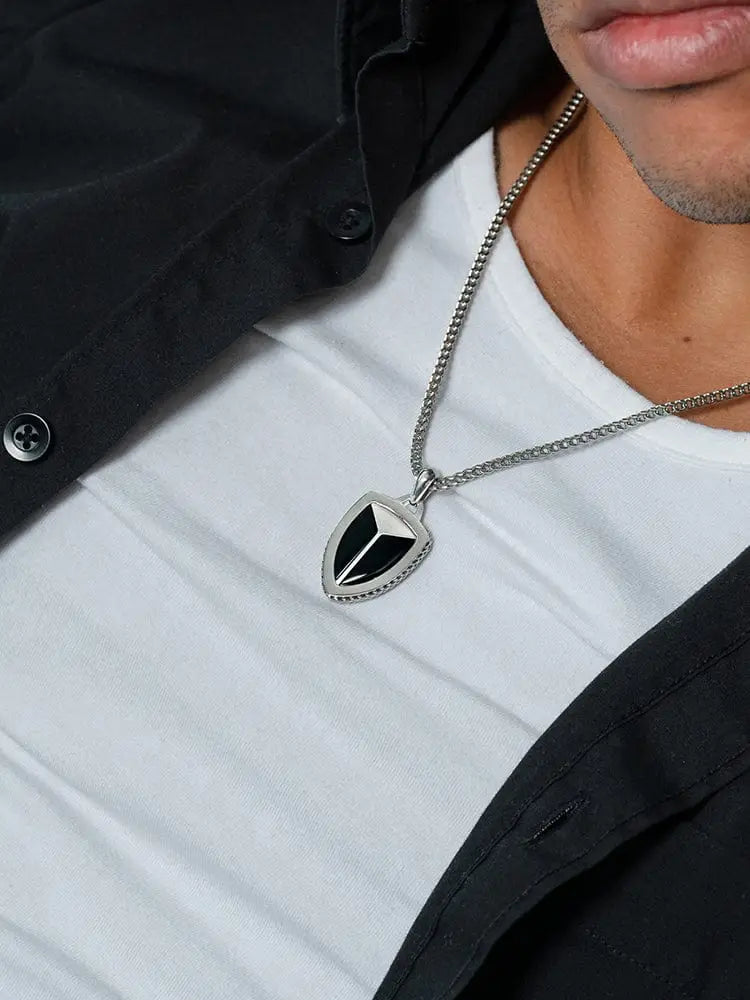 Silver shield-shaped black onyx pendant with triangular inlay on a 316l stainless steel chain